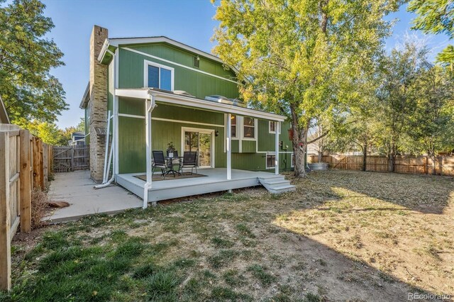 back of house featuring a fenced backyard and a wooden deck