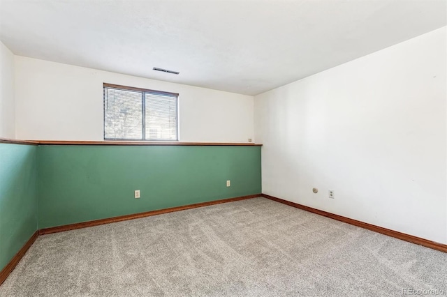 carpeted empty room with baseboards