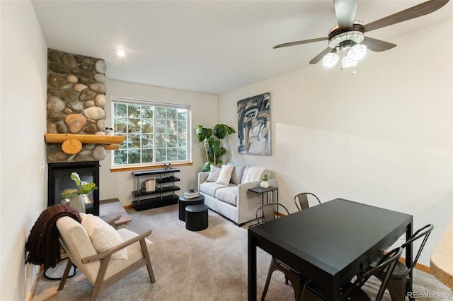 carpeted living room with a fireplace and baseboards