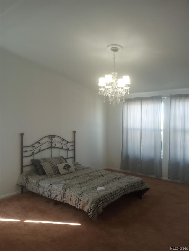 5511 Ridgetop Ct, Alamosa, CO 81101 - bedroom featuring a chandelier and carpet flooring