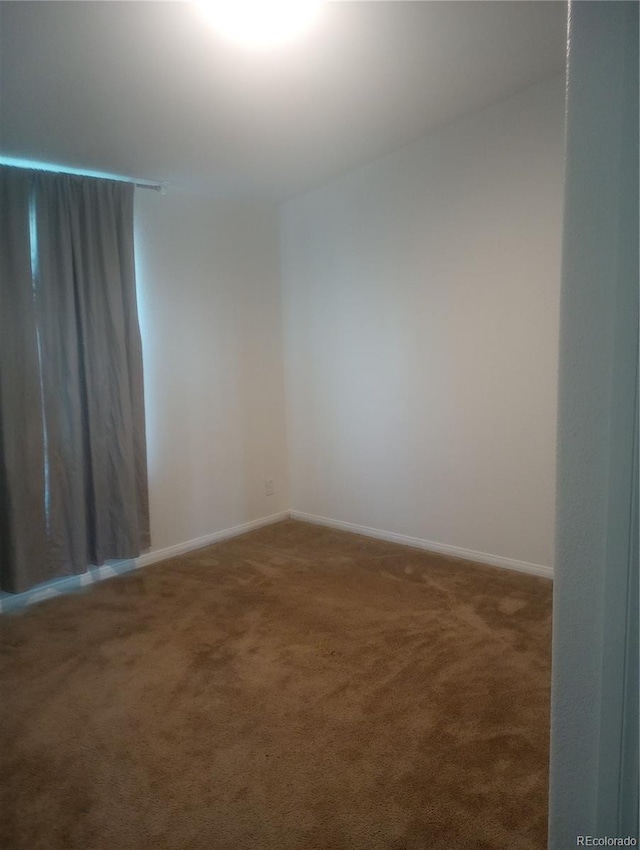 5511 Ridgetop Ct, Alamosa, CO 81101 - carpeted empty room featuring baseboards