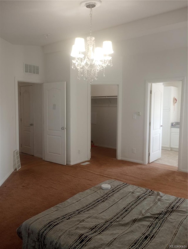 5511 Ridgetop Ct, Alamosa, CO 81101 - bedroom featuring a chandelier, light carpet, a closet, a walk in closet, and a high ceiling