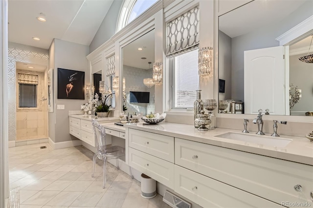 bathroom featuring vanity, vaulted ceiling, and walk in shower