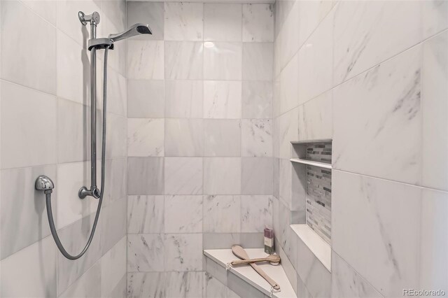 bathroom with a tile shower