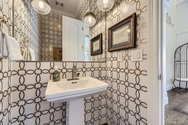 bathroom featuring hardwood / wood-style floors and crown molding