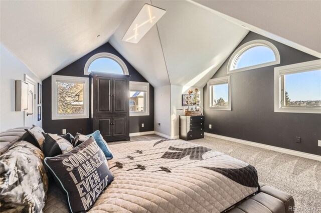 bedroom featuring vaulted ceiling, light colored carpet, and multiple windows