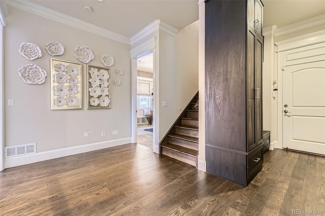 stairway featuring hardwood / wood-style floors and ornamental molding