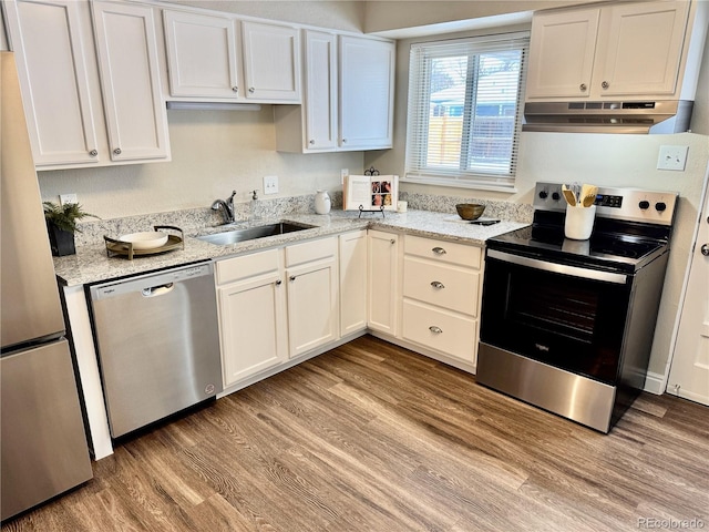 kitchen with stainless steel appliances, sink, and white cabinets