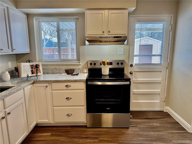 kitchen featuring white cabinetry, a wealth of natural light, stainless steel range with electric cooktop, and light stone counters