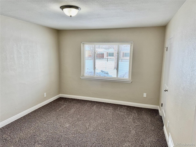 spare room with a textured ceiling