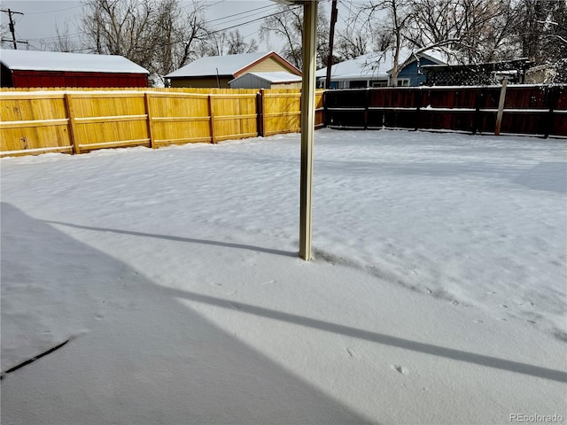 view of yard layered in snow