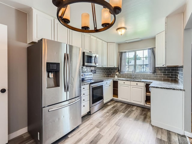 10736 Logan Ct, Northglenn, CO 80233 - kitchen with stainless steel appliances, light wood-type flooring, backsplash, and white cabinetry