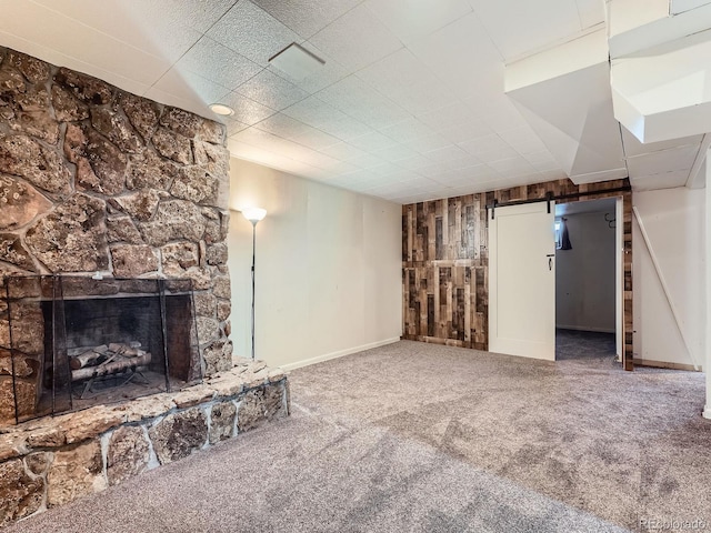 10736 Logan Ct, Northglenn, CO 80233 - unfurnished living room with carpet, wood walls, and a fireplace