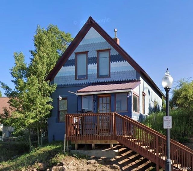 back of property with a wooden deck