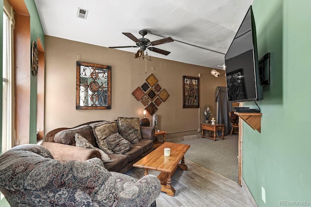 carpeted living room featuring ceiling fan