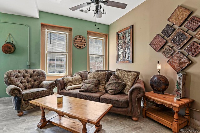 living room with hardwood / wood-style flooring and ceiling fan