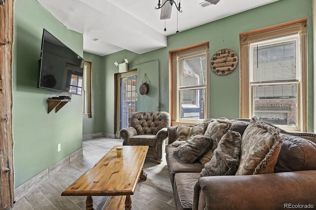 living room featuring wood-type flooring, a fireplace, and ceiling fan