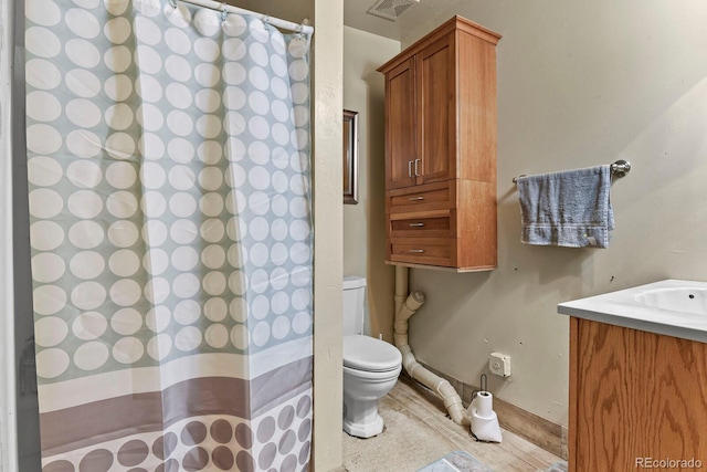 bathroom featuring vanity and toilet