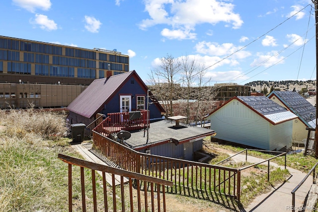 exterior space featuring a wooden deck and an outdoor structure