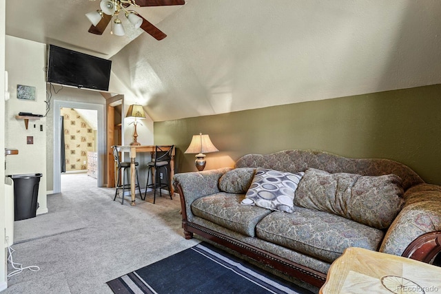 living room featuring vaulted ceiling, ceiling fan, carpet, and a textured ceiling