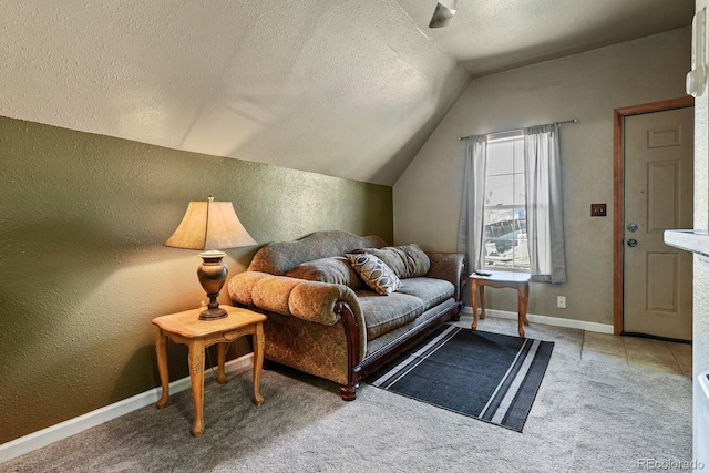 bedroom featuring a textured ceiling, carpet floors, and vaulted ceiling