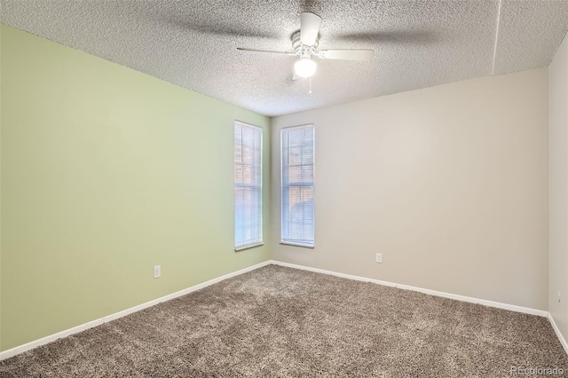 spare room with ceiling fan, a textured ceiling, carpet, and baseboards