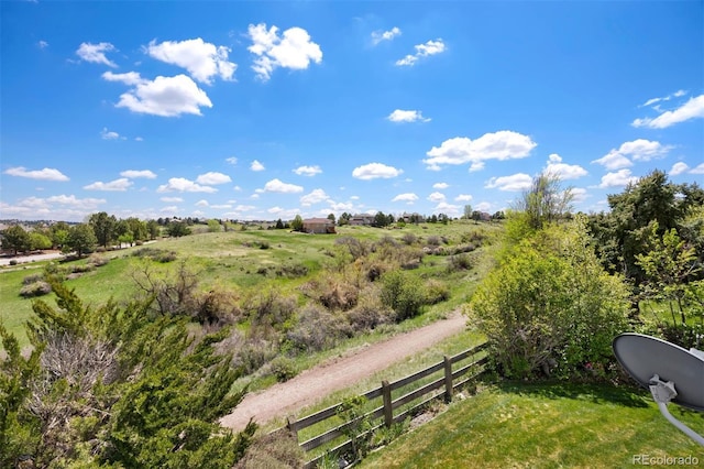 view of yard featuring fence and a rural view