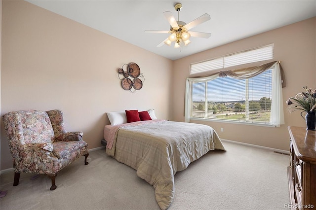 bedroom with baseboards, light carpet, and a ceiling fan