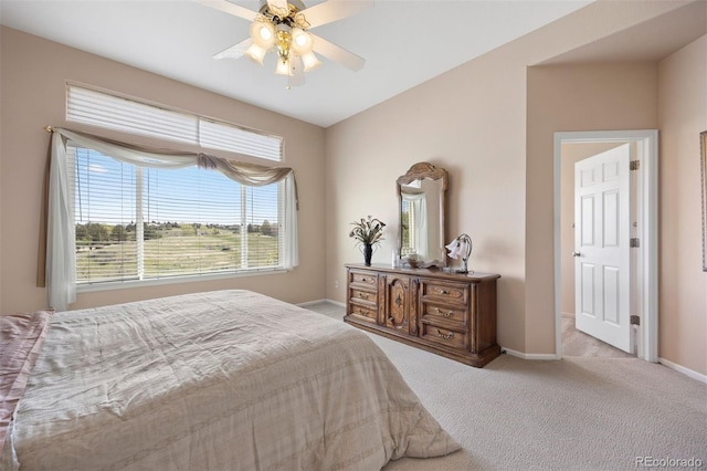 carpeted bedroom with baseboards and a ceiling fan
