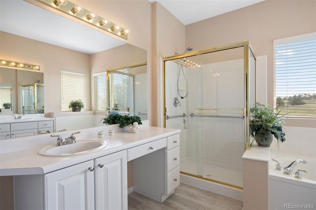 full bathroom featuring a shower stall, a bath, and plenty of natural light