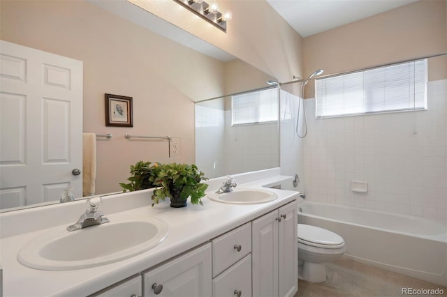full bathroom featuring toilet, double vanity, and bathtub / shower combination