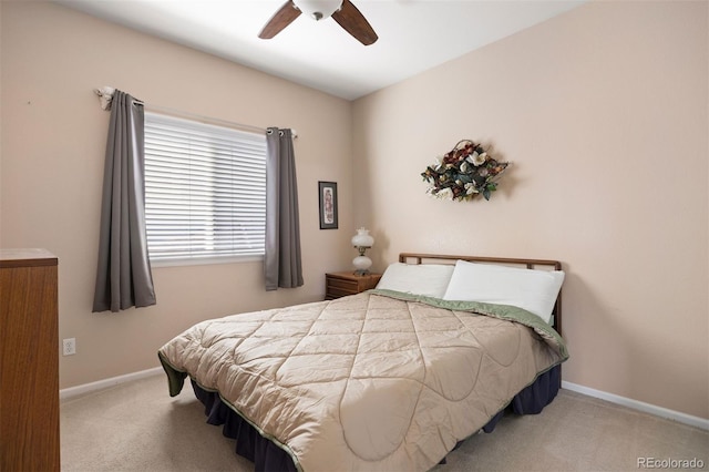 carpeted bedroom featuring baseboards and a ceiling fan