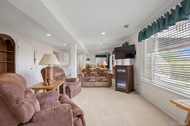 living room featuring light carpet, recessed lighting, and baseboards