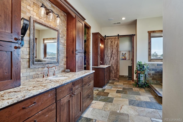 bathroom with plenty of natural light and vanity