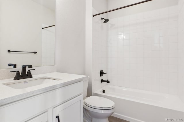 full bathroom featuring vanity, toilet, and tiled shower / bath