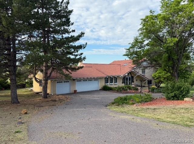 17852 E Long Ave, Centennial, CO 80016 - single story home featuring a tile roof, a garage, driveway, and stucco siding