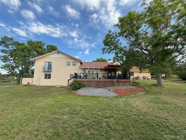 17852 E Long Ave, Centennial, CO 80016 - rear view of house with a deck, a yard, and stucco siding