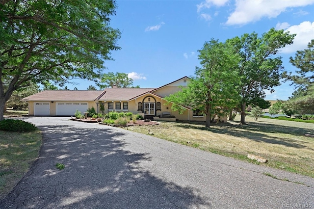 17852 E Long Ave, Centennial, CO 80016 - single story home featuring stucco siding, a garage, asphalt driveway, a chimney, and a front lawn