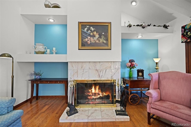 17852 E Long Ave, Centennial, CO 80016 - living area featuring wood finished floors, a tile fireplace, and lofted ceiling