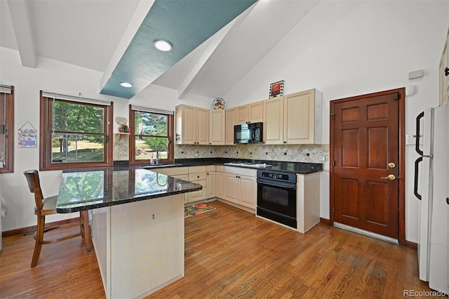 17852 E Long Ave, Centennial, CO 80016 - kitchen featuring black appliances, tasteful backsplash, wood finished floors, and recessed lighting
