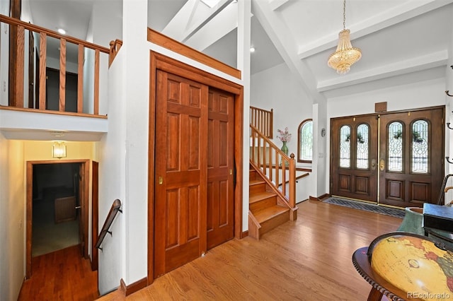 17852 E Long Ave, Centennial, CO 80016 - entryway with wood finished floors, beam ceiling, high vaulted ceiling, stairway, and a chandelier