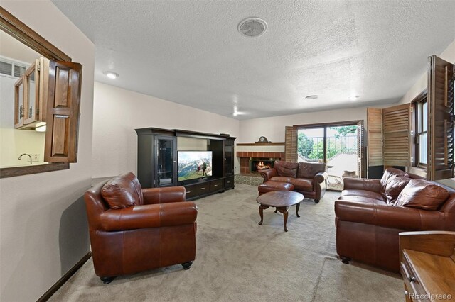 17852 E Long Ave, Centennial, CO 80016 - living room featuring light carpet, a glass covered fireplace, and a textured ceiling