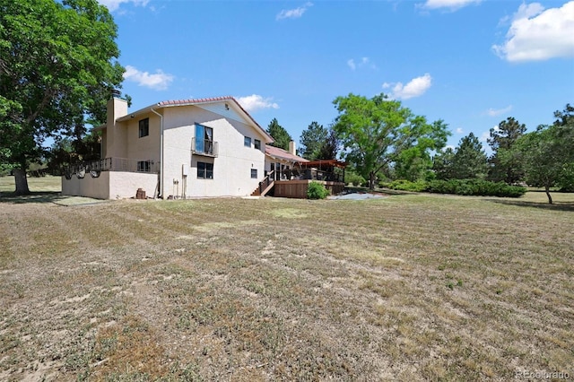 17852 E Long Ave, Centennial, CO 80016 - view of home's exterior featuring a chimney, a wooden deck, a lawn, and stairway