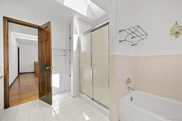 17852 E Long Ave, Centennial, CO 80016 - bathroom featuring a shower with door, a skylight, a bathtub, and tile patterned flooring