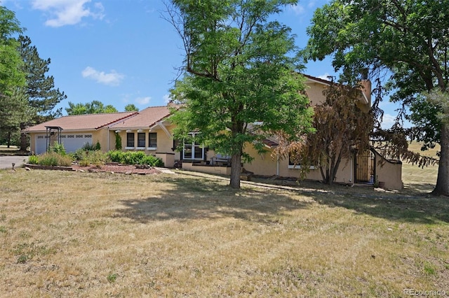 17852 E Long Ave, Centennial, CO 80016 - view of front facade featuring stucco siding, a garage, a front yard, and a chimney