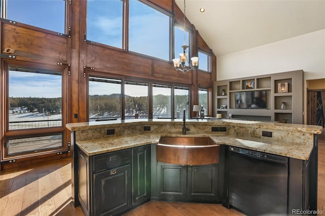 kitchen featuring high vaulted ceiling, sink, light stone countertops, black dishwasher, and a chandelier