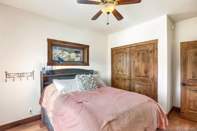 bedroom with light wood-type flooring, a closet, and ceiling fan