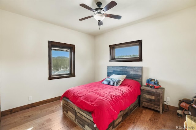 bedroom featuring hardwood / wood-style floors and ceiling fan