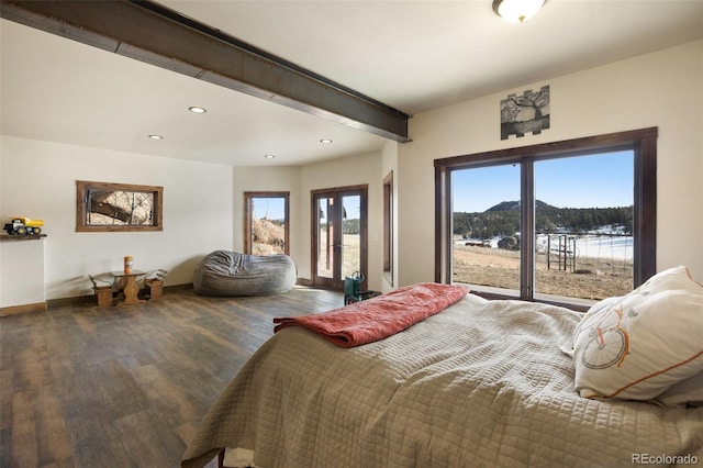 bedroom featuring a water view and dark wood-type flooring