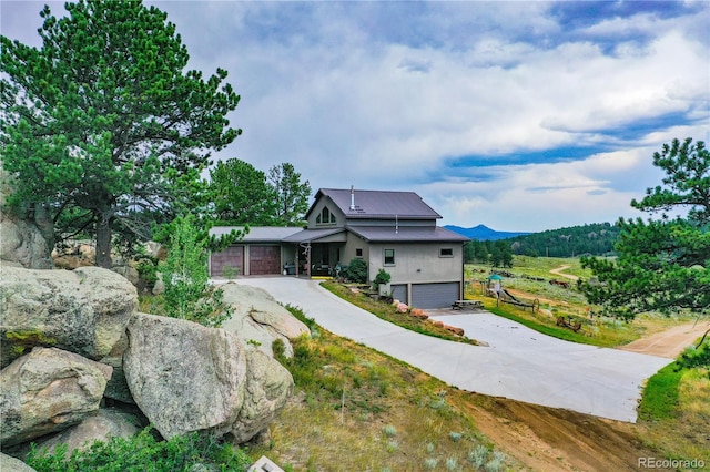 view of front of property featuring a mountain view and a garage